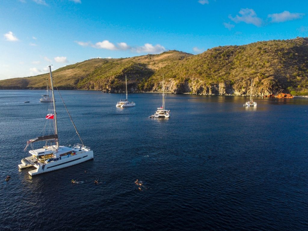 Broadreach Catamaran in bay by Ile Fourche in the Caribbean Leewards