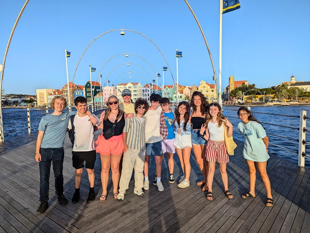 Broadreach students on bridge in Willemstad, Curacao with colorful houses in background