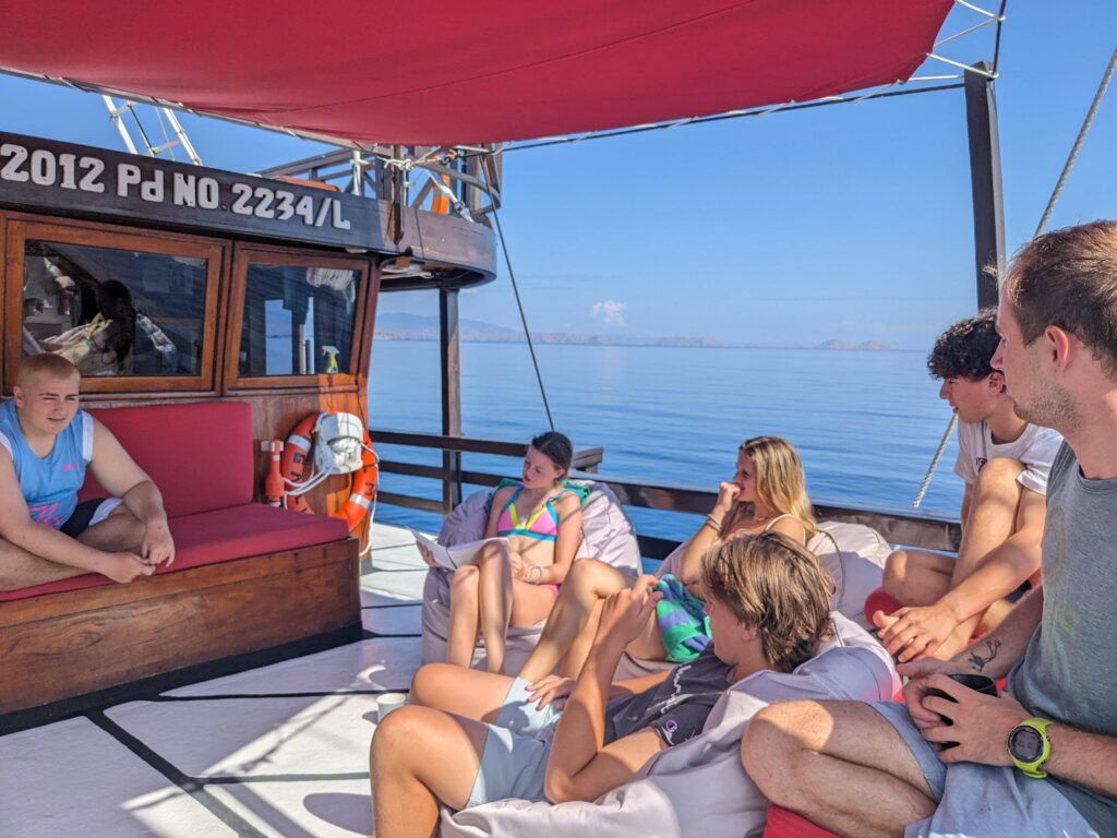 Broadreach students on the deck of a liveaboard boat in Komodo